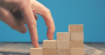 Getting career growth concept, Fingures walking on stacked wooden blocks stairs